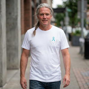 20260529182849-1f15b8c3-c5a0-6296-925a-0a0bea90101a-1.png Promotion of Prostate Cancer Awareness T-Shirt — Hands Holding Blue Ribbon Tee